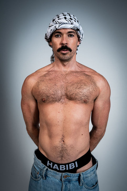 Model wearing the black 3EIB Habibi English jockstrap with HABIBI waistband and keffiyeh
