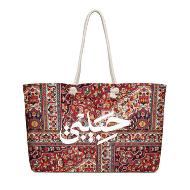 Oversized weekender bag with red rug-inspired print, white Arabic Habibi lettering and cream rope handles