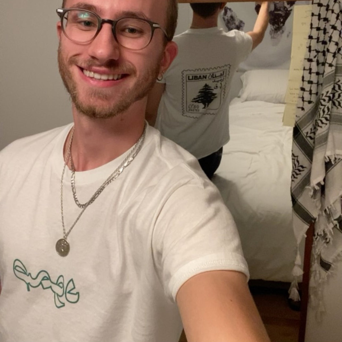 A person wearing an Arab diaspora tee in a mirror portrait